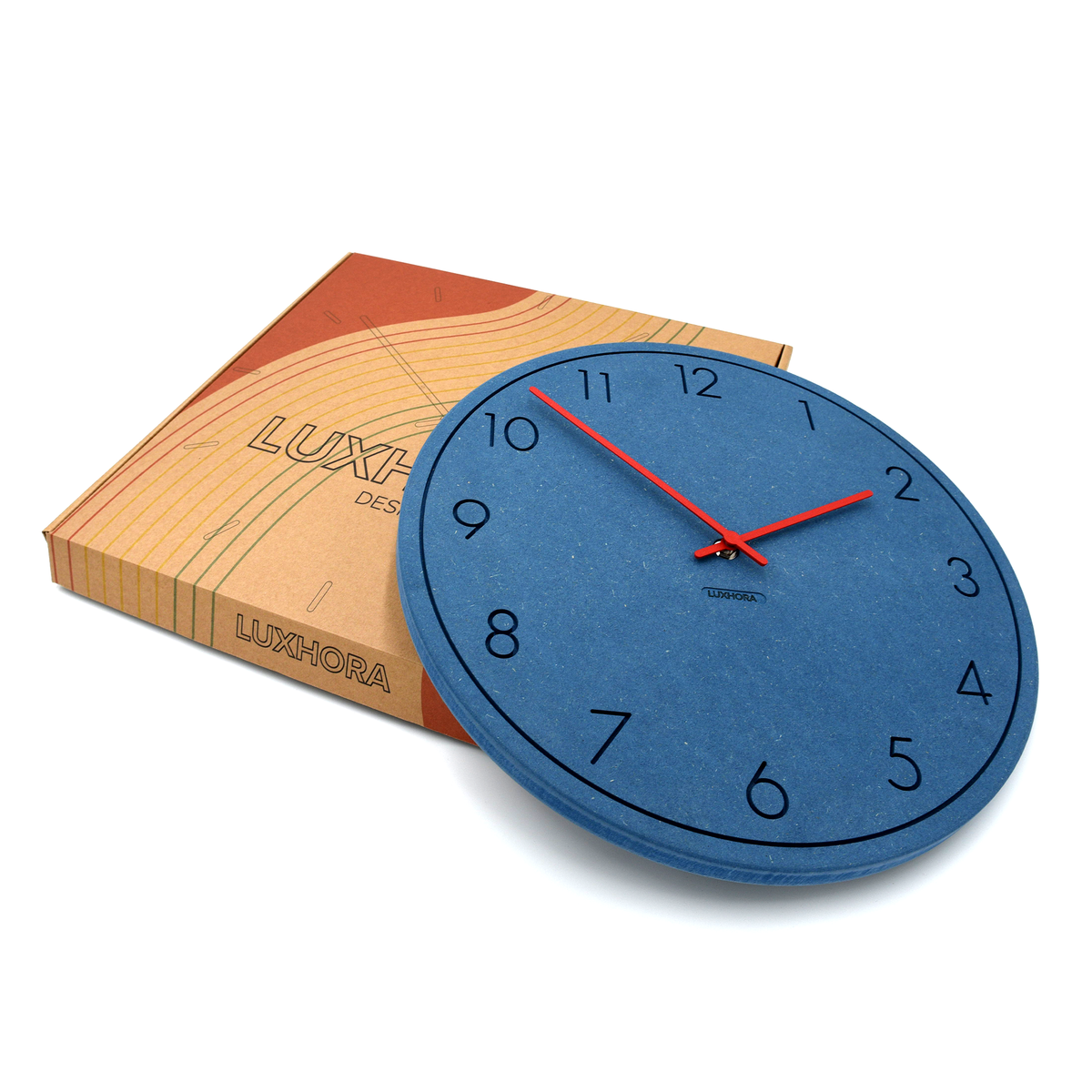 LUXHORA Numera Wanduhr in Valchromat Blau vor ihrer Verpackung