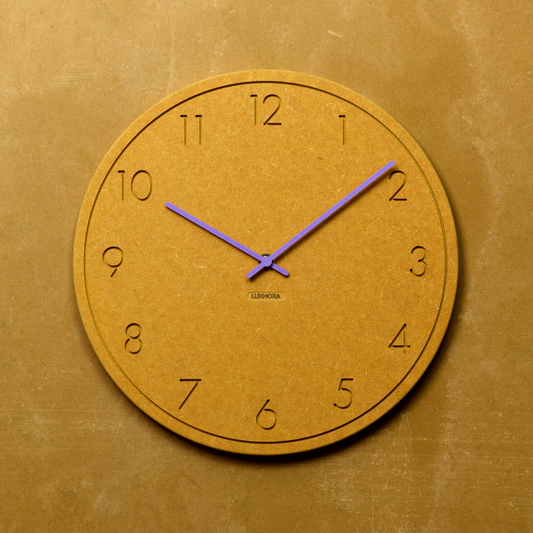 LUXHORA Numera Wanduhr in Valchromat Gelb an einer Wand